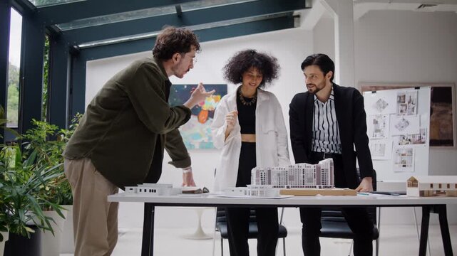 Professional team examines realistic architectural model at table