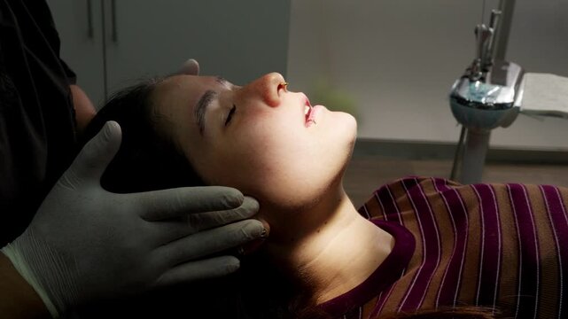 Dentist examining patient's jaw and mouth