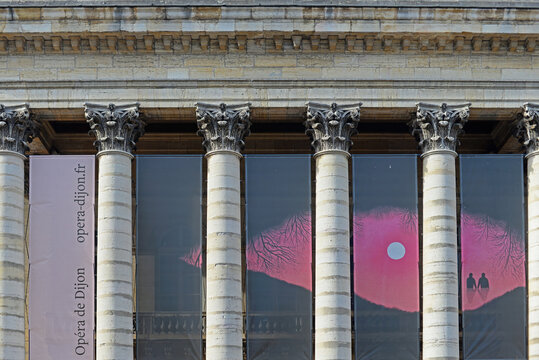 DIJON, FRANCE &ndash; APRIL 29, 2026:  Detail of the facade of the opera building with builboards of the 2026 program and Corinthian columns decorated with acanthus leafs