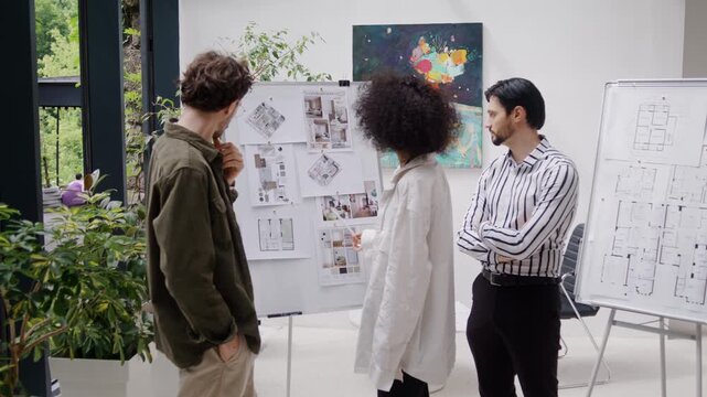 Experienced designers attentively examine interior plans