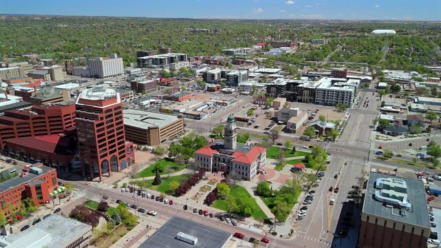Aerial drone reveal of historic courthouse with clock tower in downtown Colorado Springs