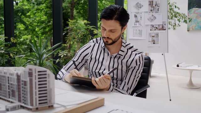 Designer thoughtfully examines elegant model of housing complex