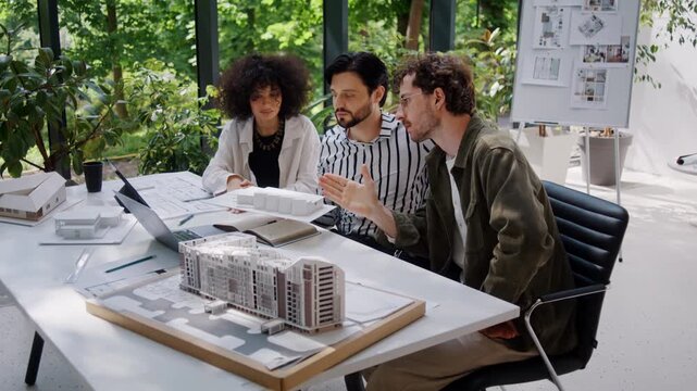 Young architect designers present building project to investors