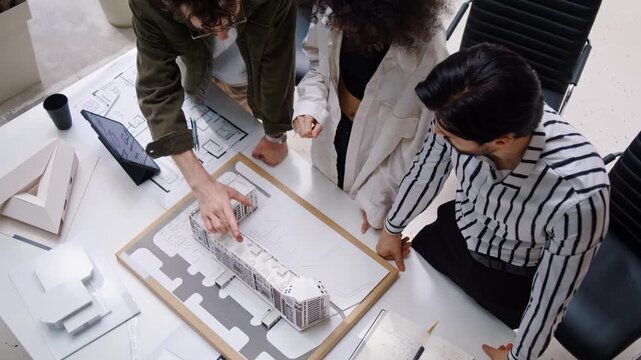 Diverse engineers plan equipment installation onto building roof