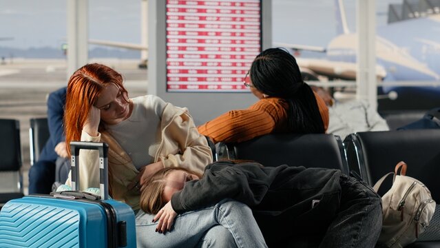 Resting on bench, cancelled flight and multiracial passengers in airport, losing flight, airline overbooking and diverse group of tired tourists sleeping on chair, waiting for another plane.