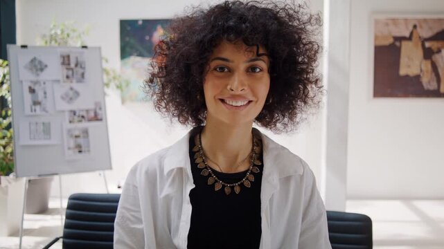 African American female designer with kinky hair smiles posing