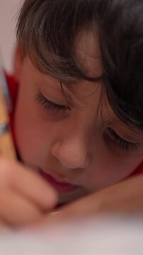Young child writing in notebook at home, highlighting early literacy, academic growth and everyday childhood learning