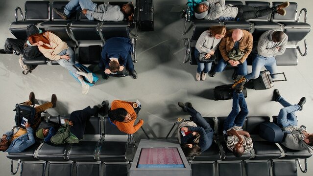 Shouting, flight delay and angry people making annoyed phone calls in busy airport terminal, top down view, Yelling, flight cancelation and frustrated travelers upset by losing plane.
