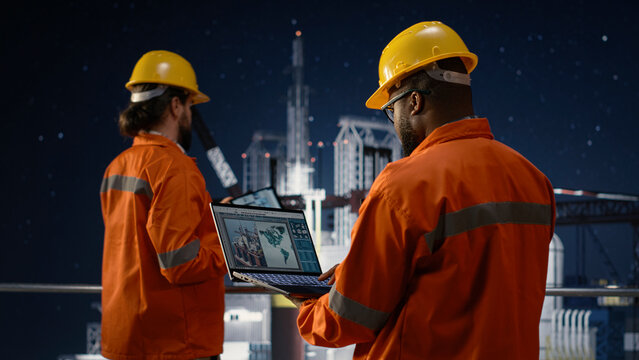 Offshore platform workers using map on laptop to circumvent embargo slowing fuel extraction operations, drilling rig colleagues searching for alternate maritime routes during oil crisis, camera A.