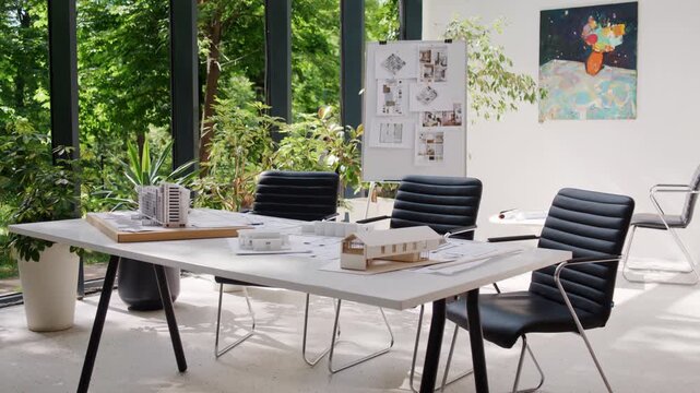 Architect office with conference table project models and board