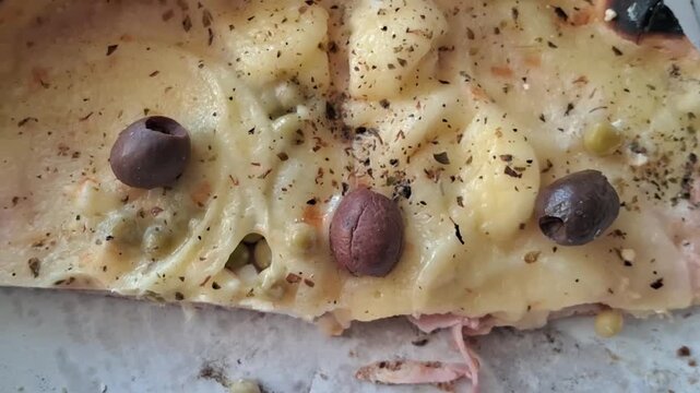 Delicious thin crust pizza slice with black olives motion video