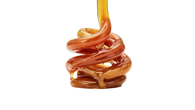 A thick stream of golden brown liquid caramel pouring downwards and twisting into a spiral shape, isolated on a solid black background