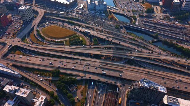 Highways and trestles with lively traffic on. Commuting in modern Boston, Massachusetts, USA at sunset. Aerial view.