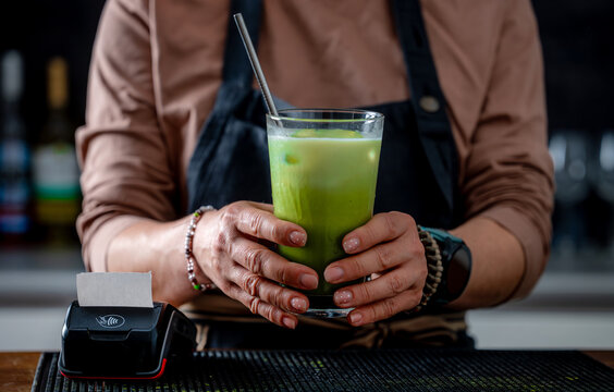 Woman Bartender Holding Matcha Latte Glass
