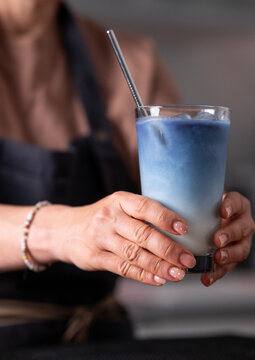 Woman Bartender Serving Blue Matcha Latte