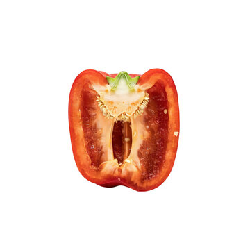 A vertical half of a fresh red bell pepper showing the hollow interior, green stem attachment, and seeds, isolated on a solid black background