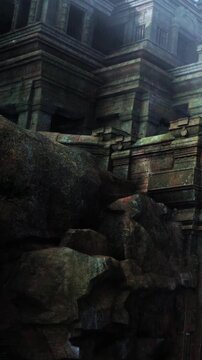 Ancient stone ruins are partially hidden by large rocks in a dense forest. Sunlight filters through trees, highlighting the weathered surfaces of the stones.