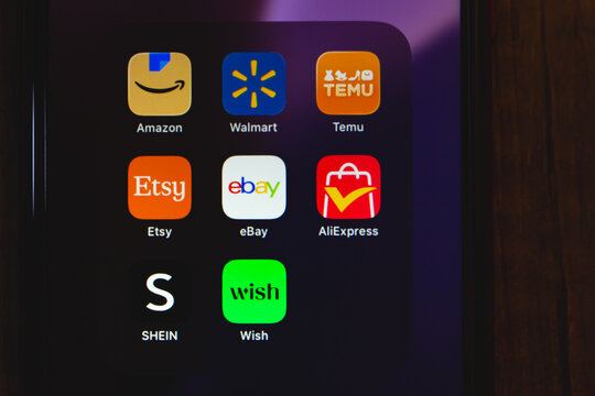 Mexico City, MEXICO - Jun 25 2026 : Online shopping app icons including Amazon, Walmart, Temu, Etsy, eBay, AliExpress, Shein, and Wish against a dark purple background.