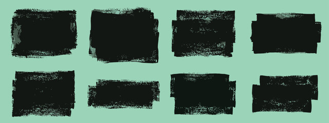 Set of eight black textured paint stroke squares and rectangles on a light green background © MadhobiRani