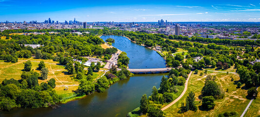 Fototapeta premium Hyde Park Serpentine aerial view with London skyline in summer sunlight