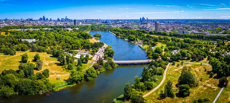 Hyde Park Serpentine aerial view with London skyline in summer sunlight