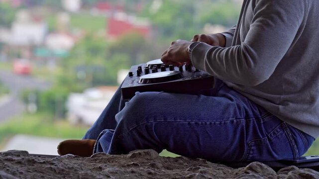 Disc jockey mixing music on a cave overlooking tlayacapan mexico