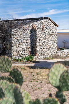 Abandoned stone building home and prickly pear cactus in Marfa, Texas