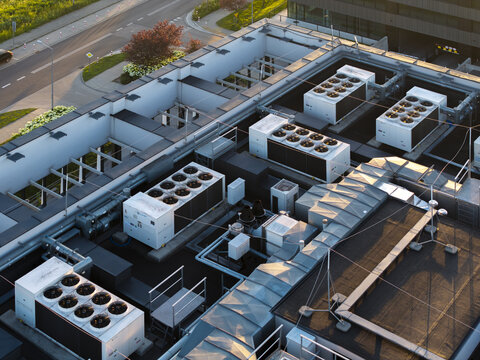 Aerial view of modern data center rooftop with multiple industrial HVAC cooling units and ventilation systems in Krakow, Lesser Poland Voivode, Poland.