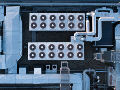 Aerial view of industrial HVAC cooling units on a rooftop of a modern data center with metallic ventilation ducts and pipes Krakow, Lesser Poland Voivode, Poland.