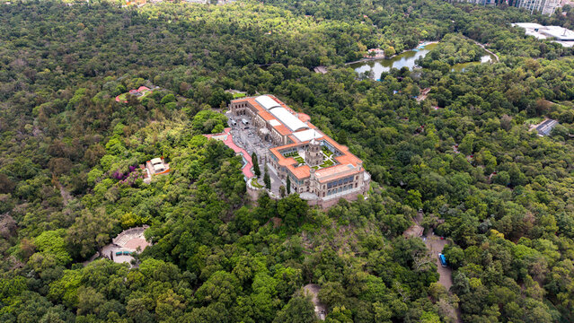 Aerial view of Chapultepec Castle and Mexico City skyline. Drone shot of historic castle, lush green park and skyscrapers on Paseo de la Reforma in CDMX.