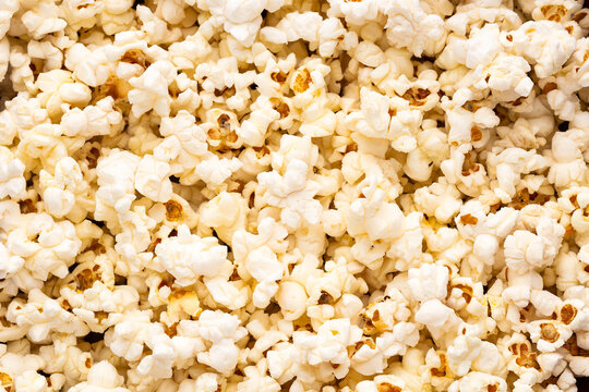 Fluffy white popcorn seen from above, perfect for illustrating food, entertainment, and fast food