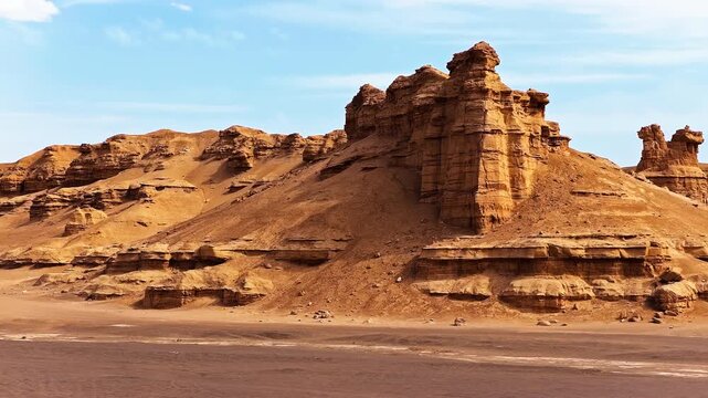 Scenic view of yardang landform in Xinjiang, China, featuring unique clay rock formations under blue sky.