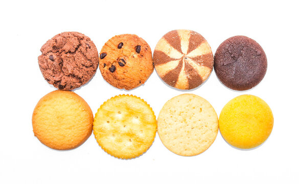 Assorted cookies and biscuits isolated on white background. Collection of sweet baked snacks including chocolate cookies, butter biscuits, crackers and sandwich cookies. 