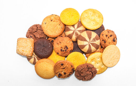 Assorted cookies and biscuits isolated on white background. Collection of sweet baked snacks including chocolate cookies, butter biscuits, crackers and sandwich cookies. 