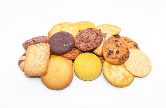 Assorted cookies and biscuits isolated on white background. Collection of sweet baked snacks including chocolate cookies, butter biscuits, crackers and sandwich cookies. 