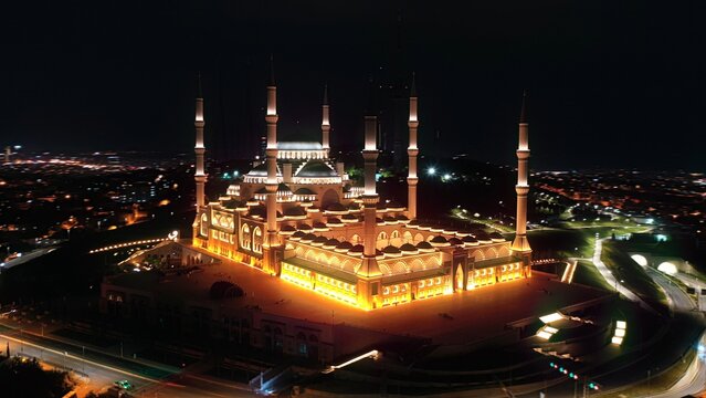&Ccedil;amlıca Mosque brilliantly illuminated at night during Ramadan, aerial hyperlapse orbiting the grand structure above Istanbul city lights