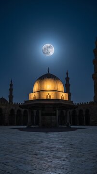 Full moon over illuminated mosque dome at night
