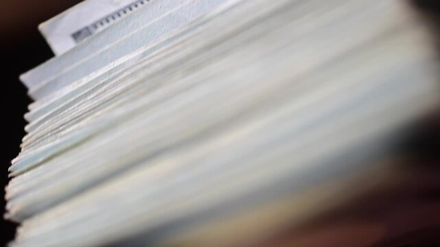 Stock of hundred dollars bills bokeh macro close up, texture, in and out of focus, abstract money finances, studio selective focus real time video