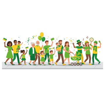 Diverse family and friends celebrating with green and yellow flags and balloons