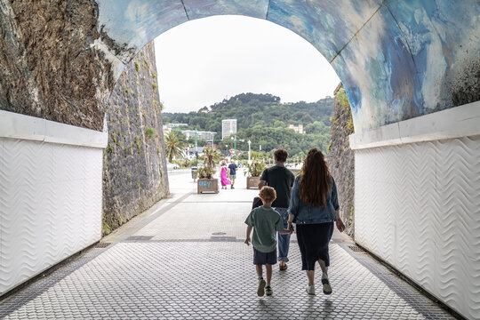 Family Walking Through a Tunnel in Europe