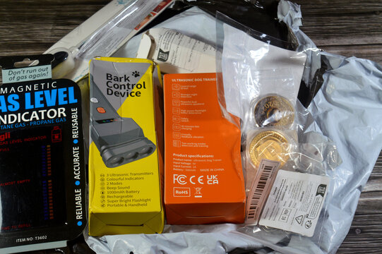 Cairo, Egypt, June 26 2026: shipping package contains a collection of diverse, everyday utility tools and electronic accessories, Magnetic Gas Level Indicator, Bark Control Devices for dog trainings