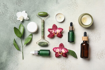 Natural skincare products with jade roller and orchids © Pixel-Shot