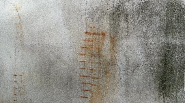 Weathered concrete wall texture with cracks, rust stains, and aged surface details, creating a distressed industrial background suitable for design, architecture, and graphic projects