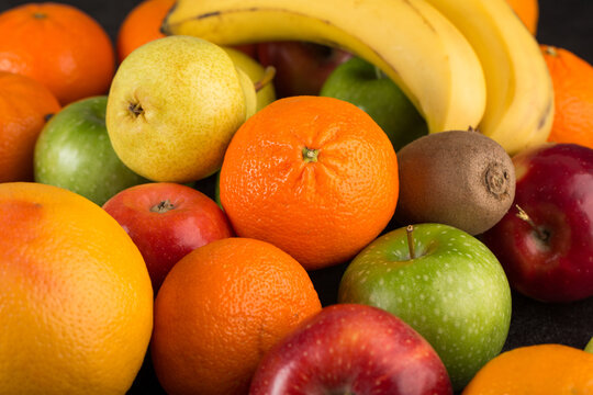 mix fruits colorful fruits ripe mellow fresh oranges and apples on dark desk