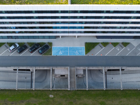 Aerial view of modern data center building with a parking lot featuring handicap spaces and a covered entrance area in Krakow, Lesser Poland Voivode, Poland.