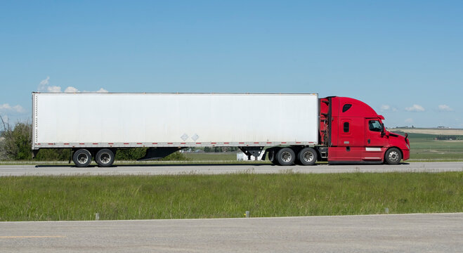 Heavy Cargo on the Road. A truck hauling freight along a highway. Taken near Airdrie, Alberta, Canada