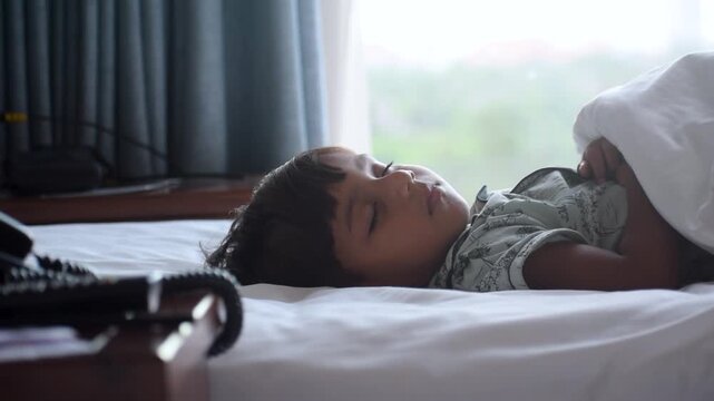 Peaceful Indian child sleeping comfortably on a clean bed with gentle breathing, capturing innocence, rest, comfort and healthy lifestyle. Cute moment before playing, highlighting cleanliness and calm
