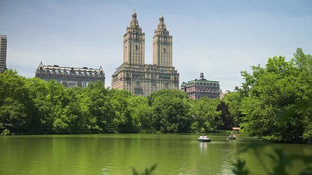 The historic San Remo apartment towers stand prominently beyond the lush landscape of Central Park.