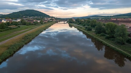 Fototapeta premium River reflecting a tranquil sky at dusk.