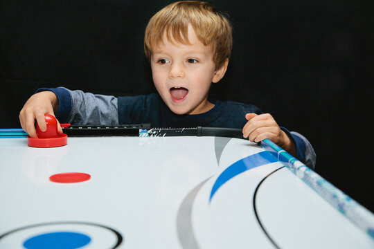 boy playing air hockey